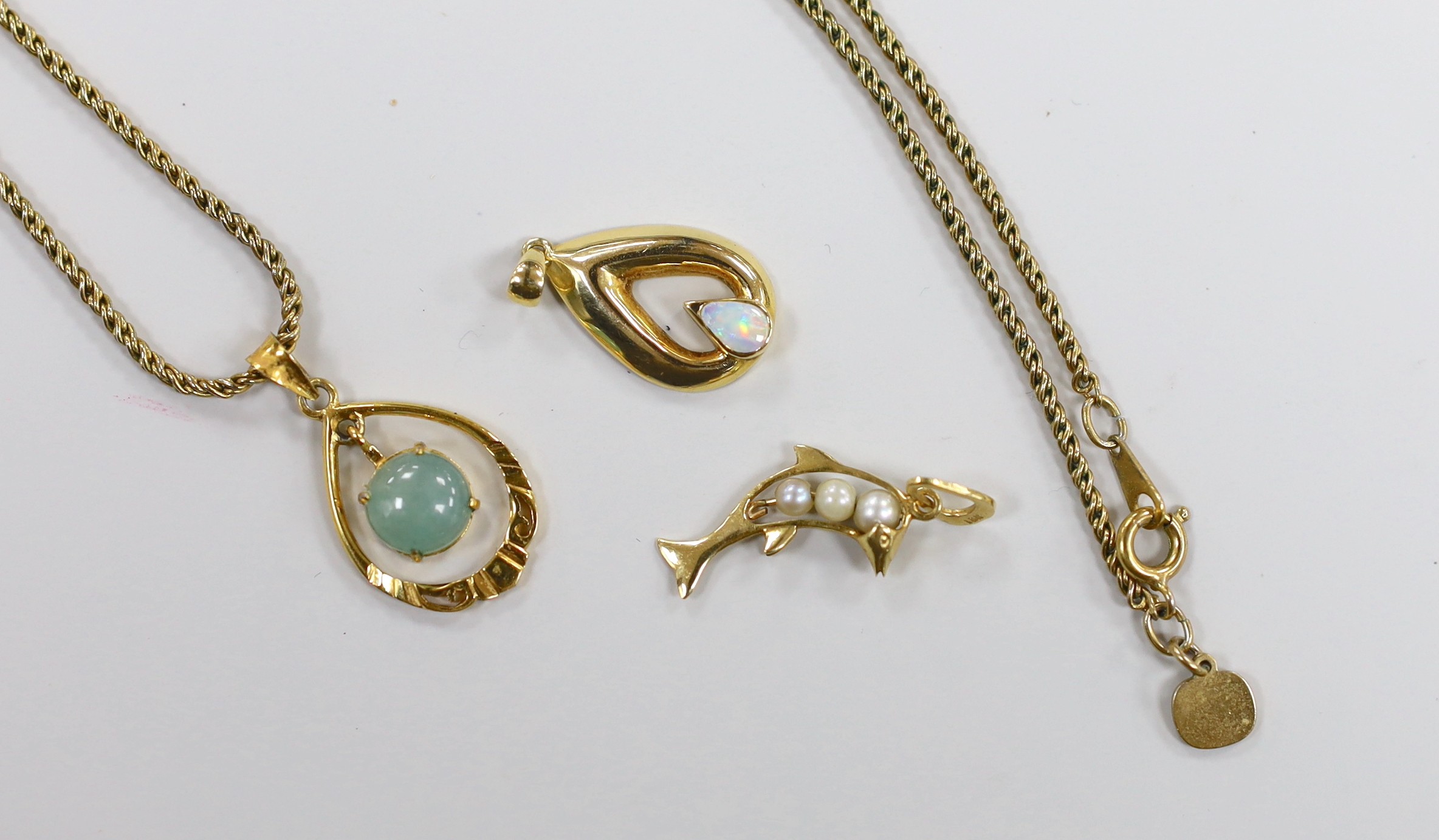 Three modern 18k and gem set small pendants, including cultured pearl set dolphin, overall 28mm and white opal set pear shape, one with gilt metal chain.
